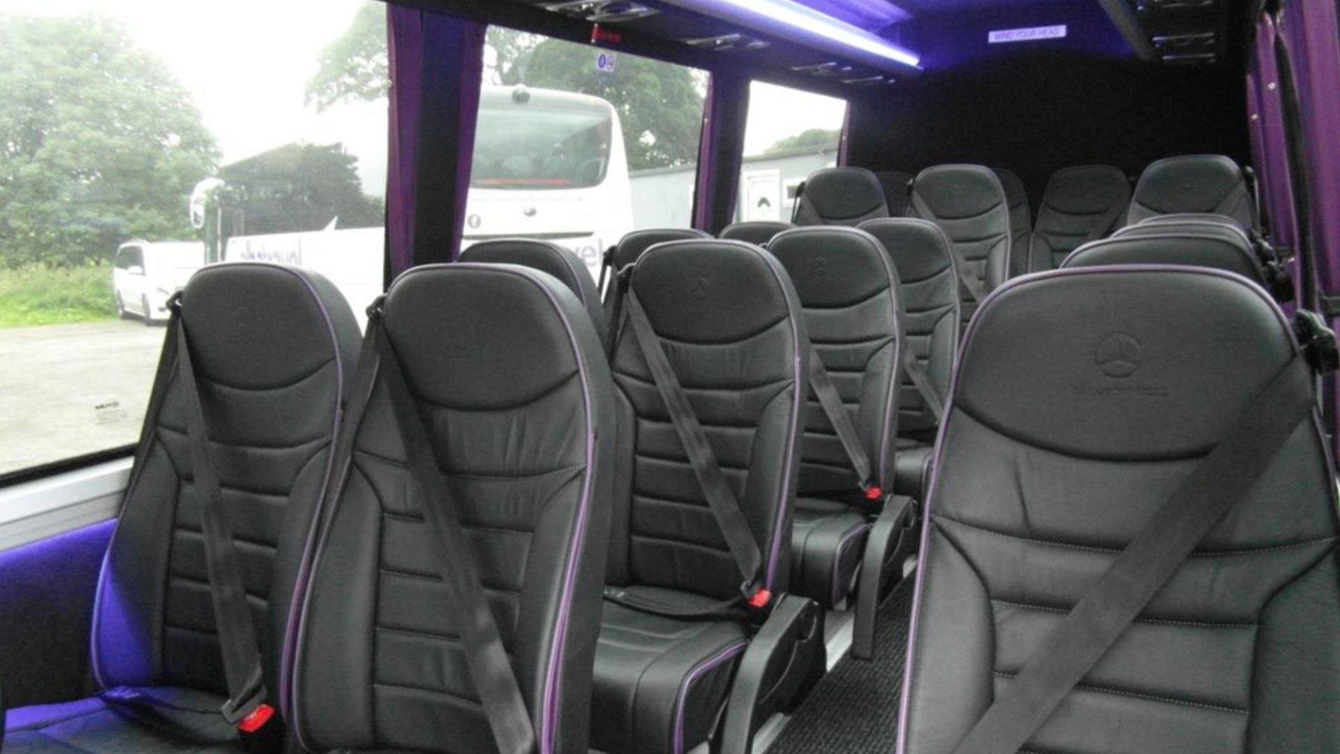 a desk with a keyboard in front of a window