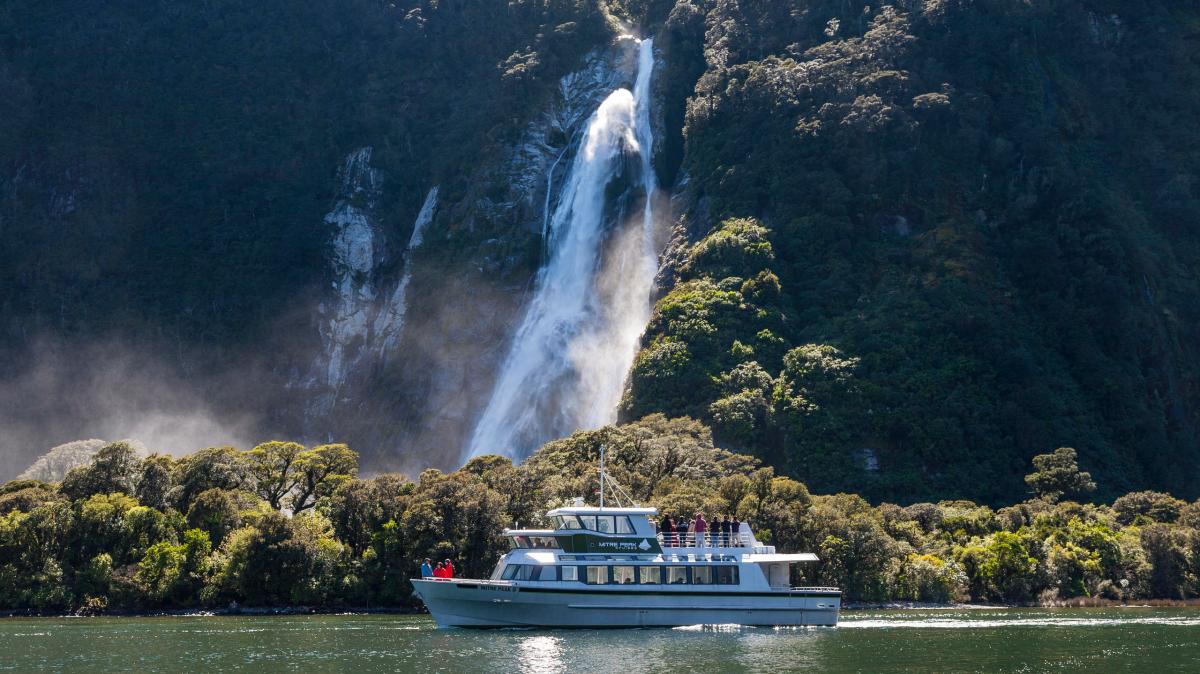 Coach Cruise Coach from Te Anau Image 2 a large waterfall over a body of water