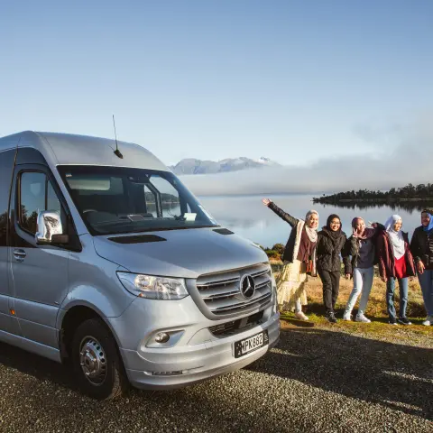 a group of people standing next to a car