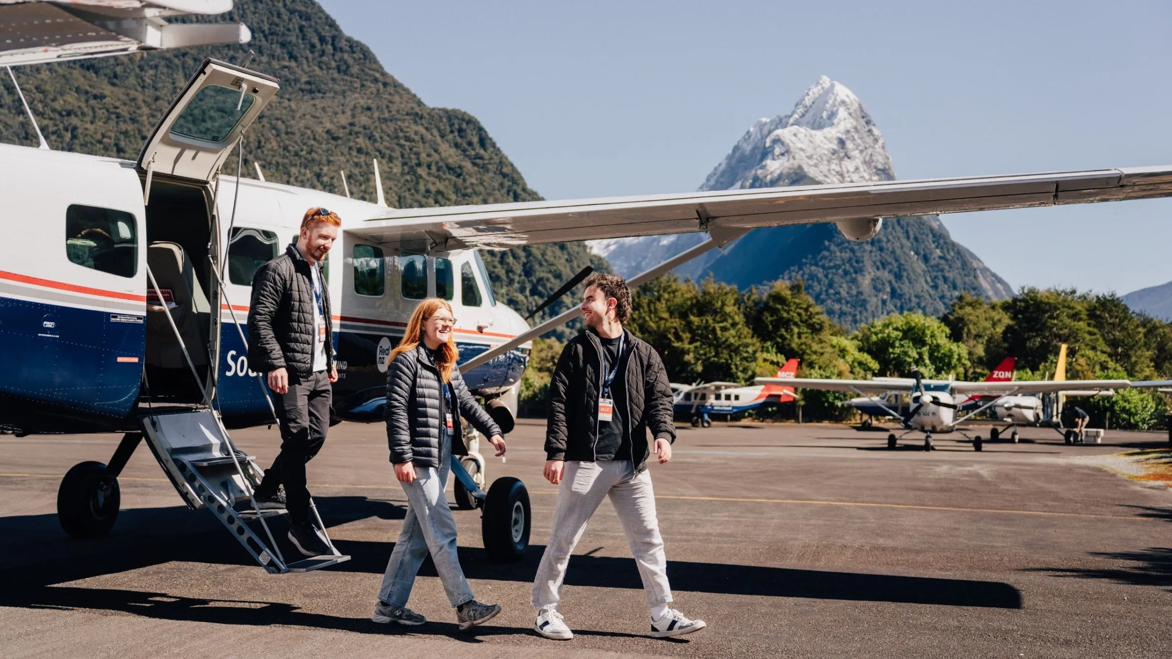 a group of people standing in a parking lot
