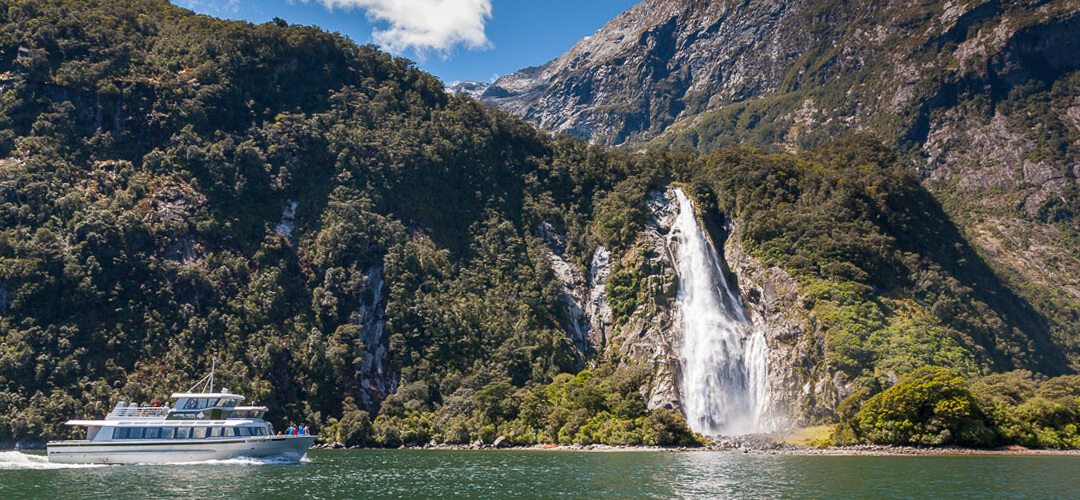 a waterfall with a mountain in the background