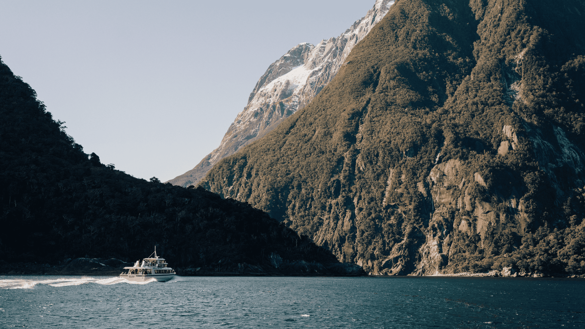 a large body of water with a mountain in the background