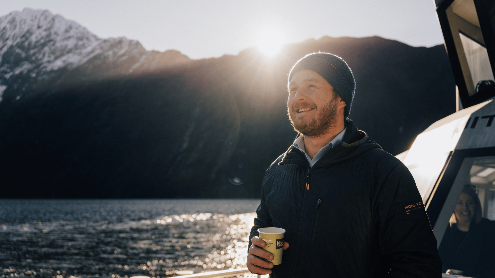 a man standing in front of a mountain