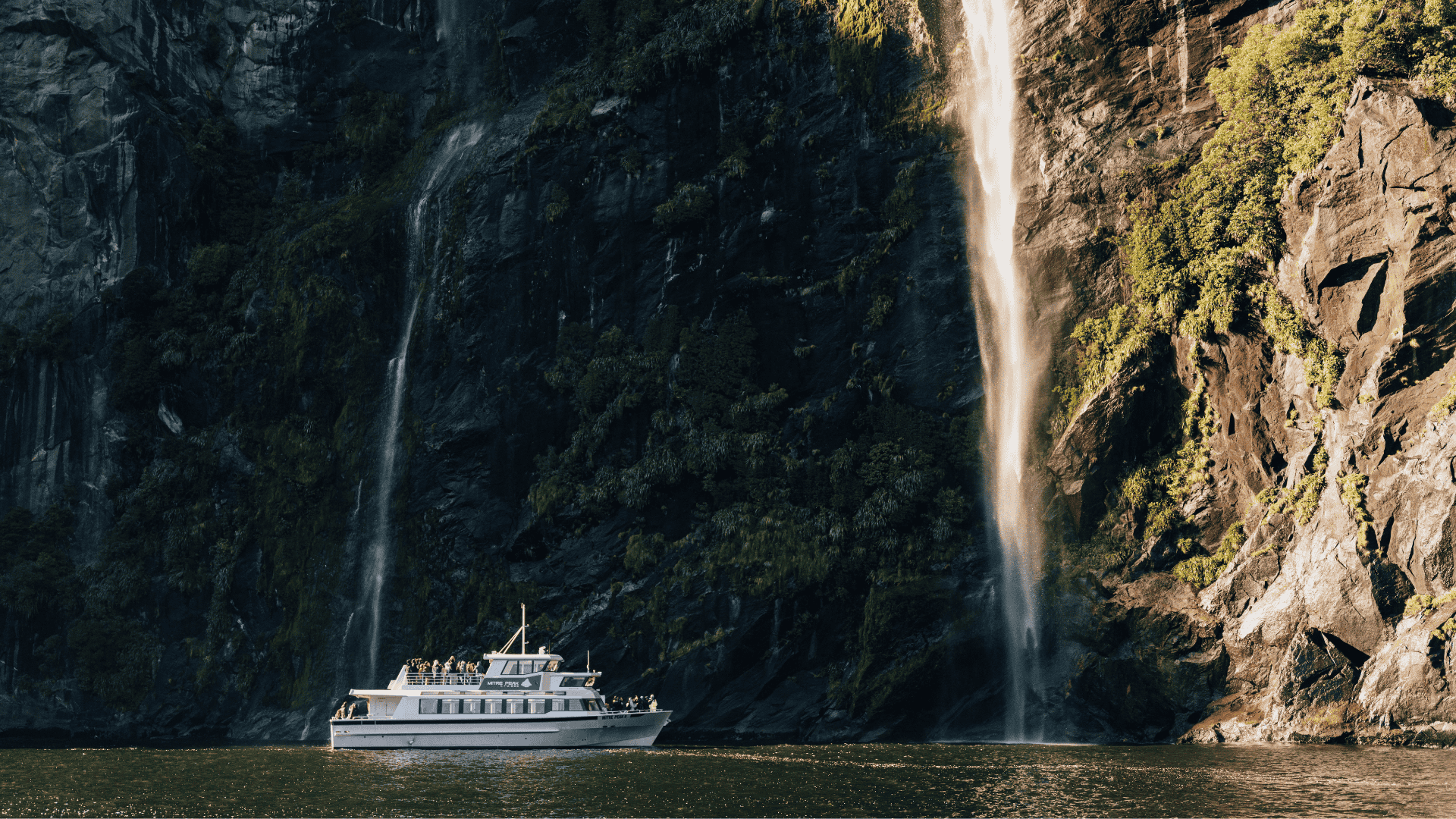 a large waterfall over some water