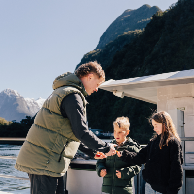 a couple of people standing on top of a mountain