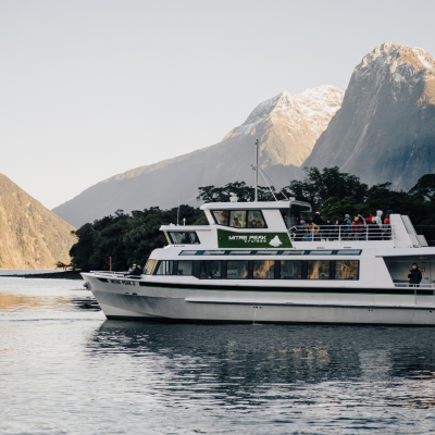a boat in the water with a mountain in the background