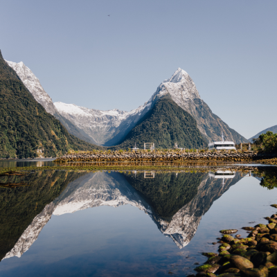 a body of water with Milford Sound in the background